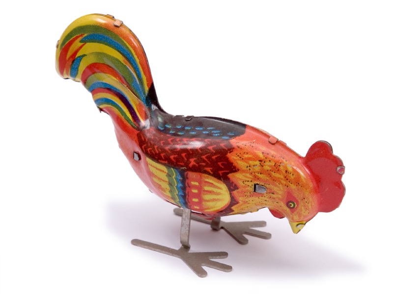 A colorful vintage metal rooster toy
